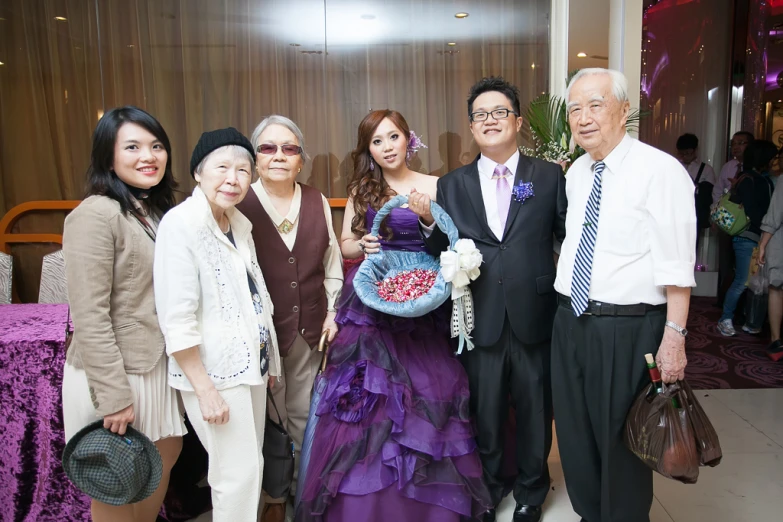 people are posing for a picture near a buffet table