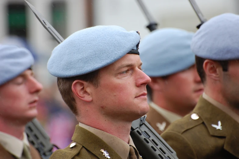 a couple of men that are wearing blue hats