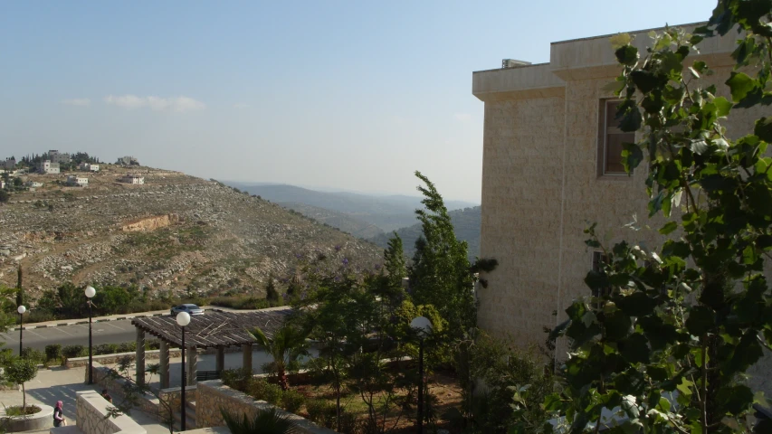 a house on top of a hill near a road