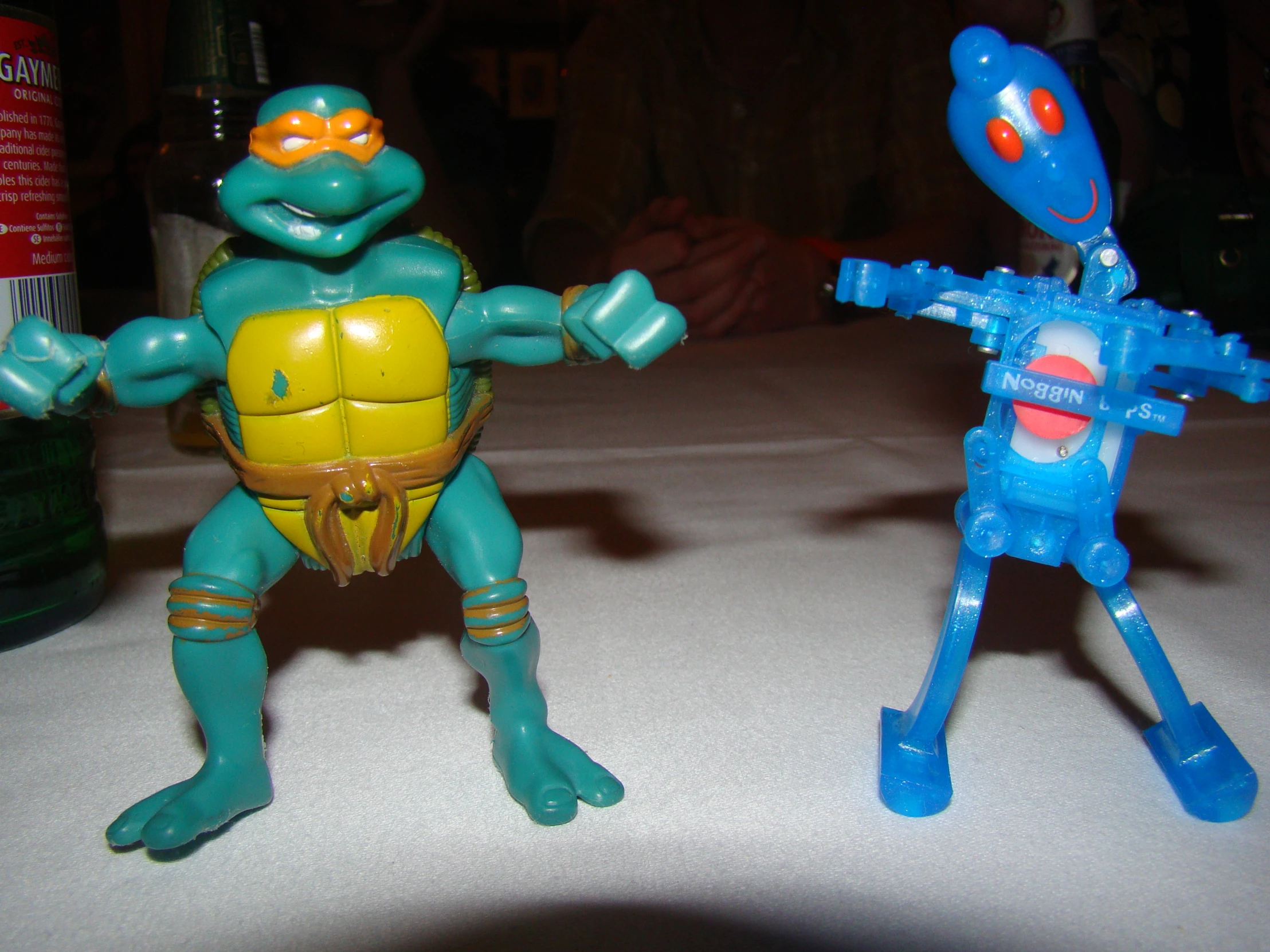 two action figures on a table holding one another
