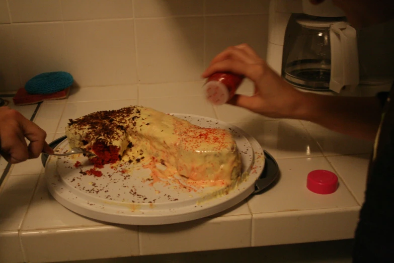 a person mixing up some kind of cake on a plate
