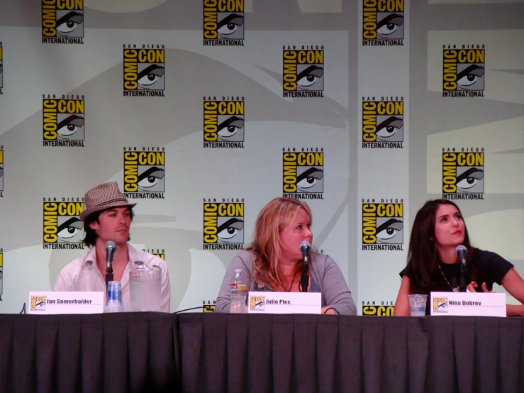 actors at a panel at a comic convention