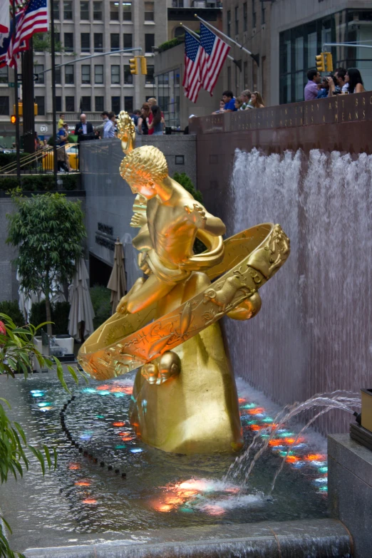 a golden statue of a woman with a surfboard