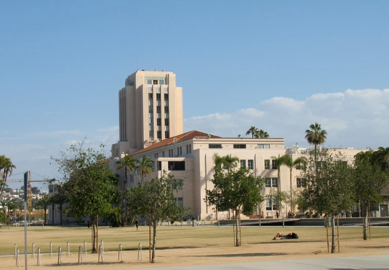 a tall building with trees in front of it