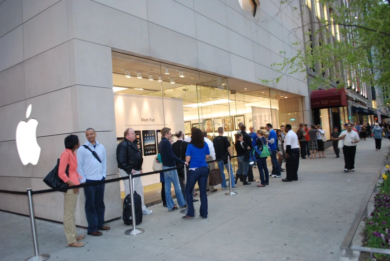 people line up to check their iphones for a new iphone