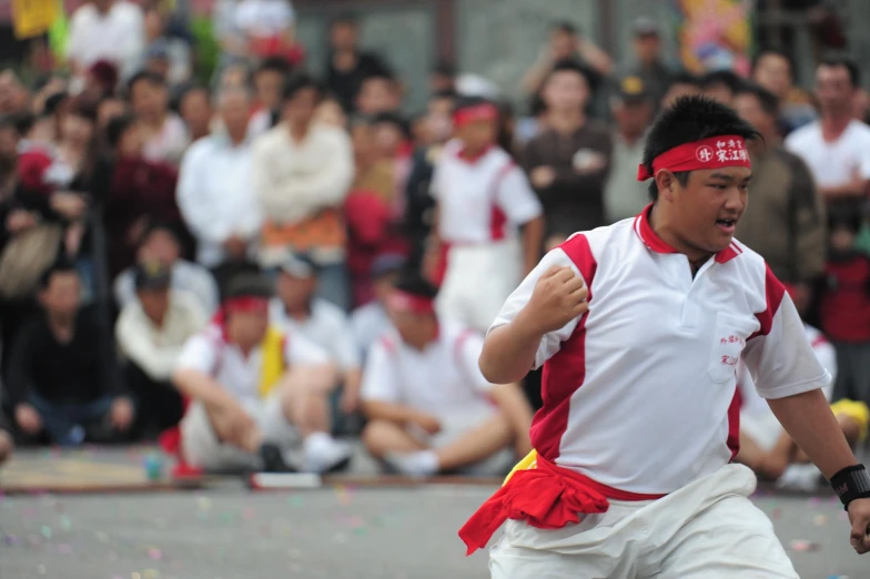 a man wearing a white and red top is playing tennis