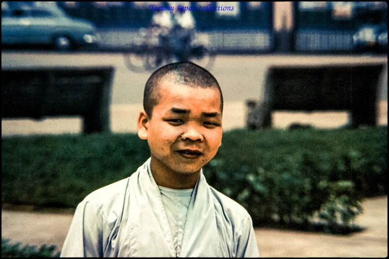 a young man looking confused in front of a busy street