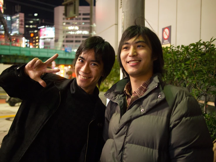 two men who are posing for the camera