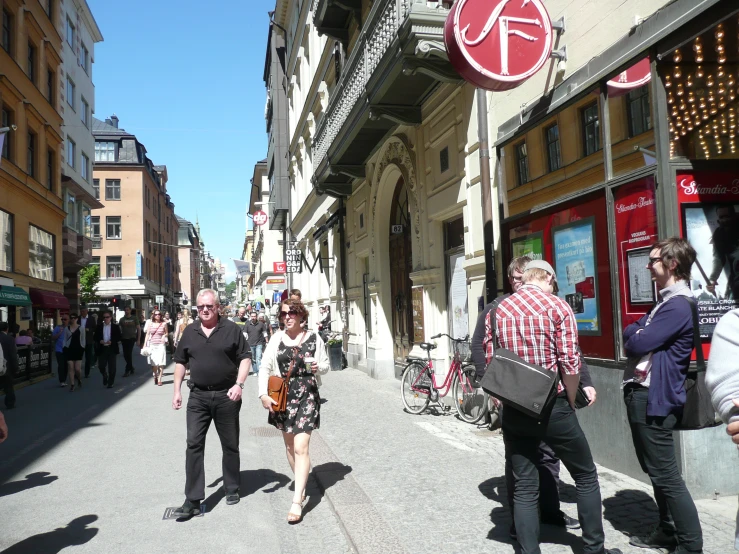 two men and a woman are walking through an old town