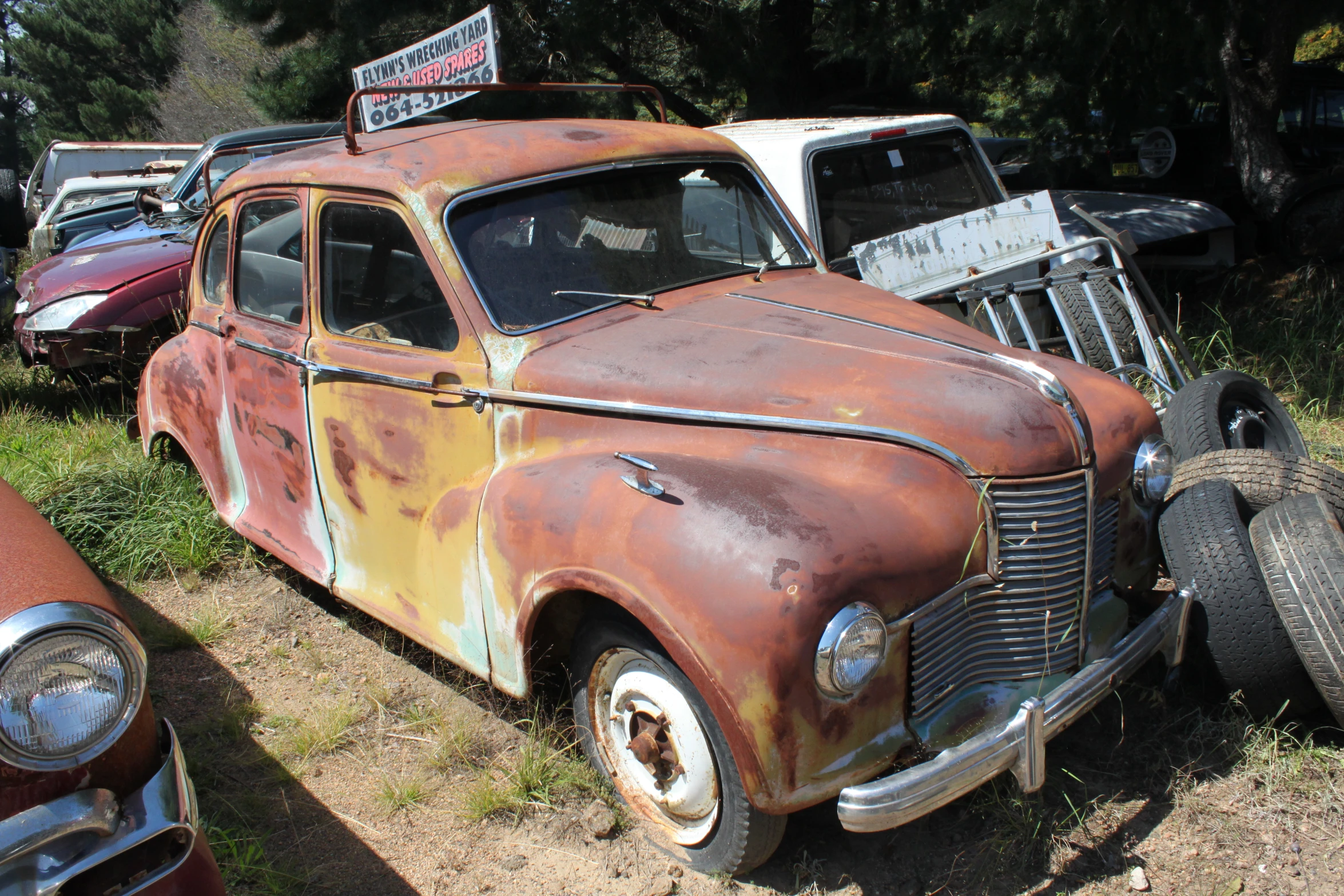 an old rusty car in a junk yard