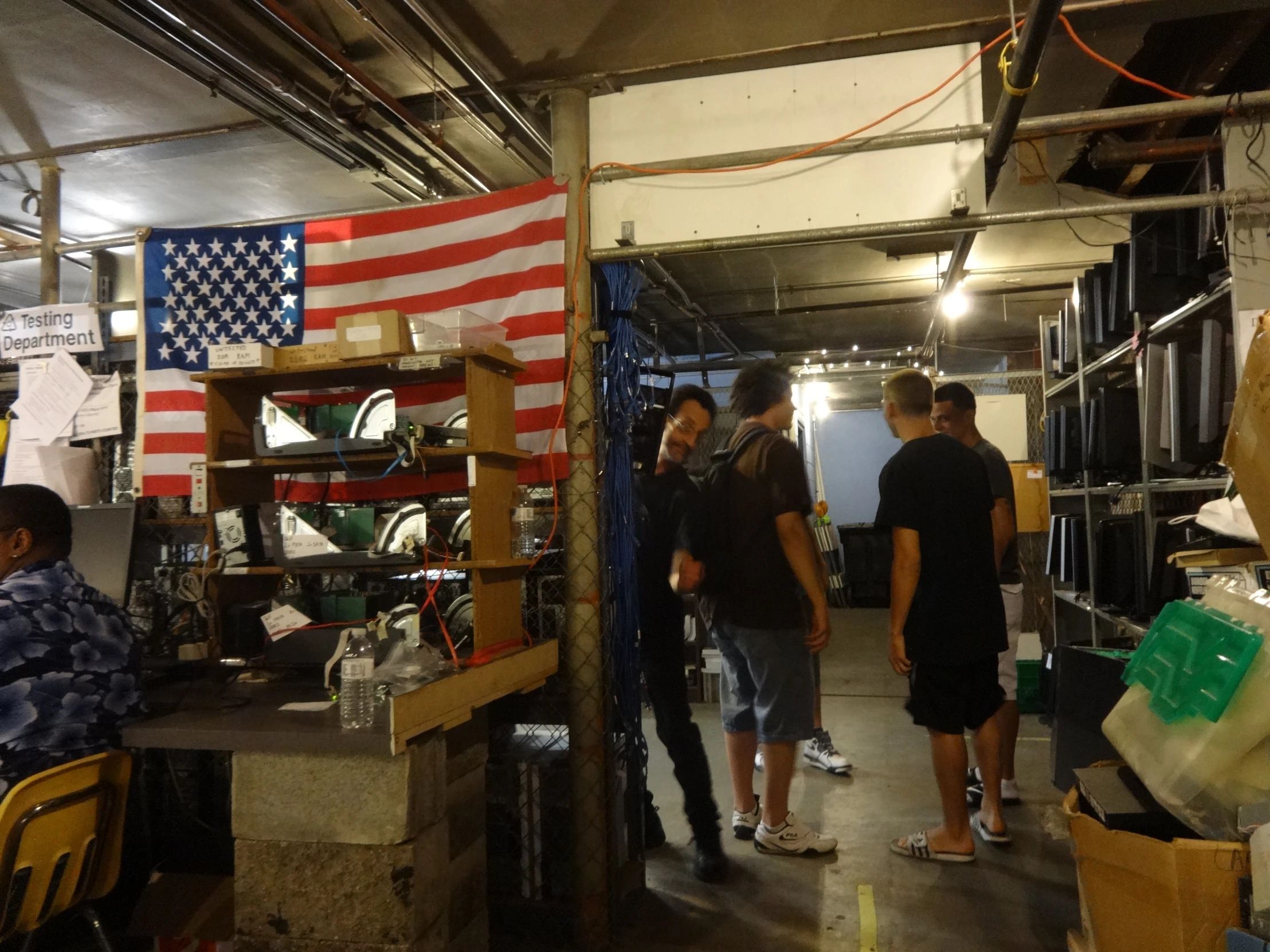 three young people standing in front of a american flag