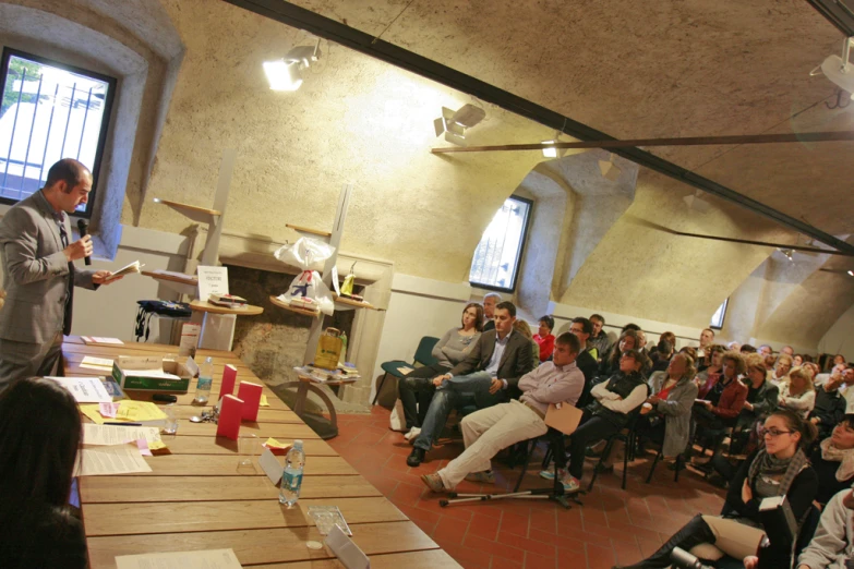 a man speaking to a large group of people