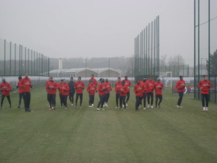 a group of soccer players standing in the fog
