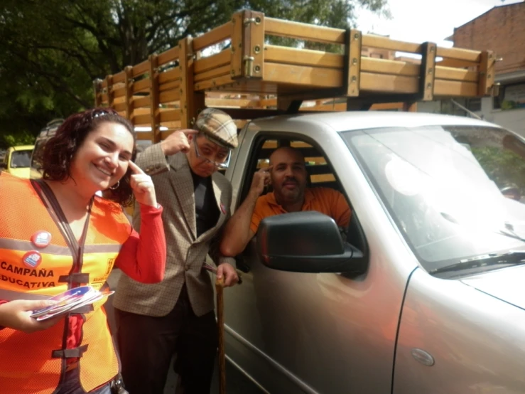 people are standing near a car with a sign on it