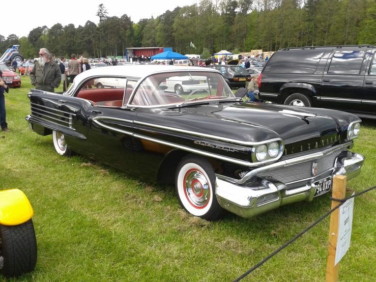 classic american car parked in a row at a car show