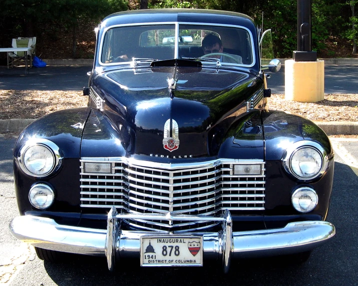 old fashioned car parked on the side of the road