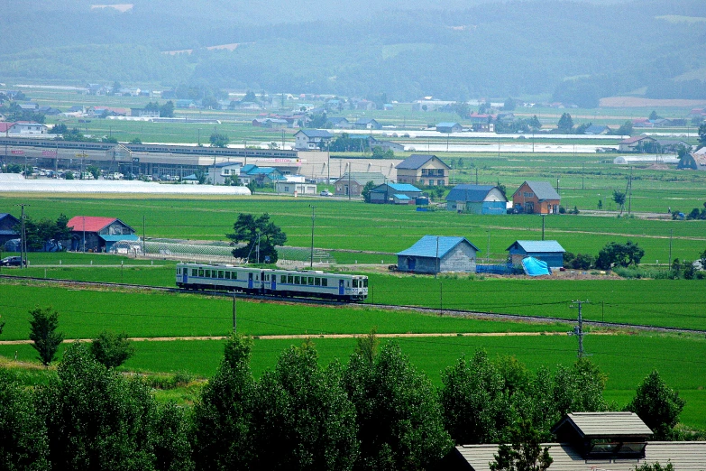 a train on a track through an open field