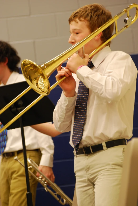 a  playing the trombone while wearing a tie