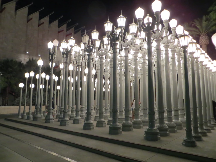 an array of street lamps line the walkways at night
