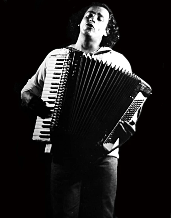 an image of a man with an accordion in his hand