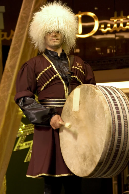 a man with a hat and a drum