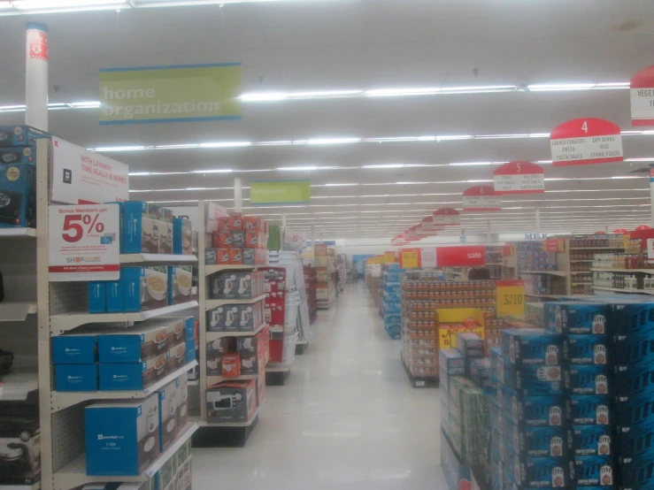 an aisle full of shelves and boxes in a store