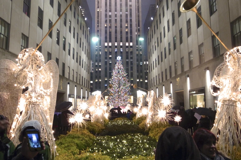 a building decorated with christmas lights and angel statues