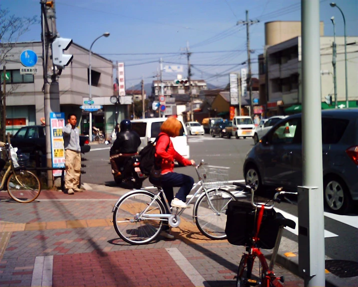 the woman is riding her bicycle down the city street