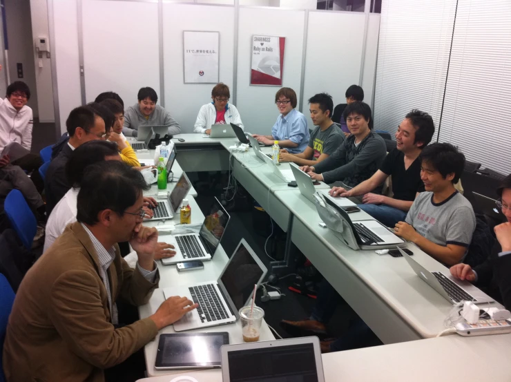 a group of people sitting around tables in a room