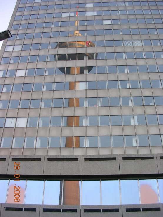 a tall building with windows and a large cross on it