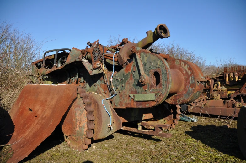 old rusted out machinery on display in a field