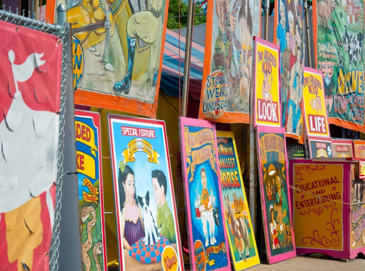 a lot of colorful street signs with posters attached