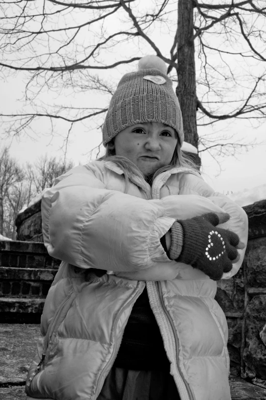 woman wearing a hat and holding a stuffed animal