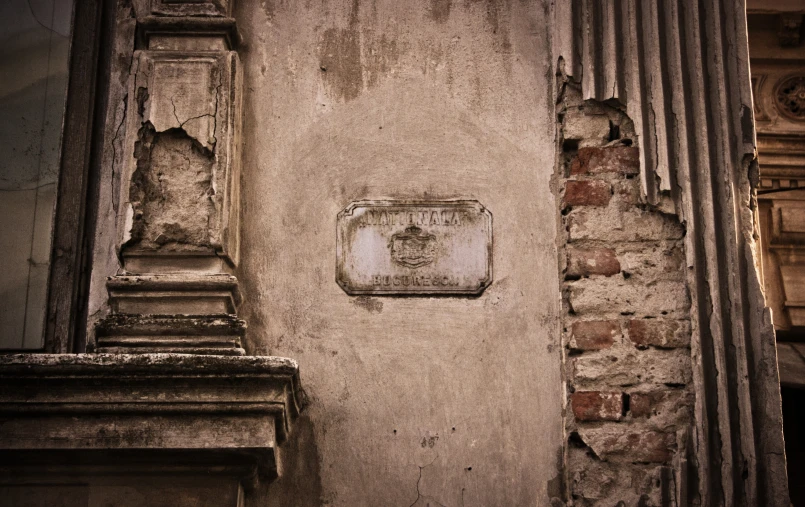 a large wall mounted plaque on a stone wall