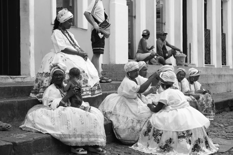 several people wearing costumes sitting and standing on steps