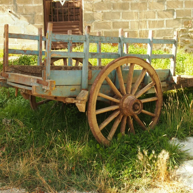 an old wooden wagon sitting outside in the grass