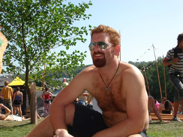 a man in glasses with some grass around him