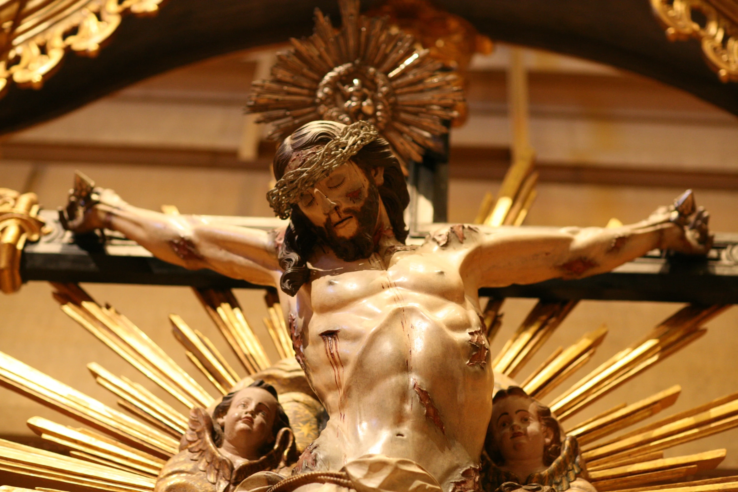 some bronze statues with gold decorations above them