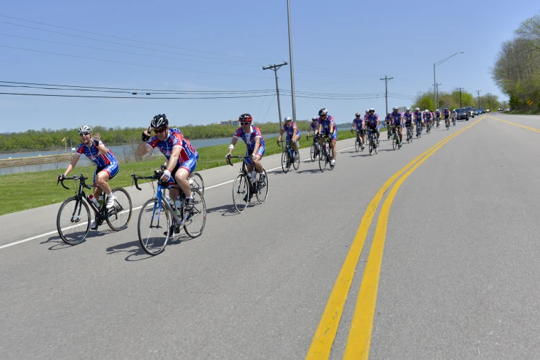 a group of men riding bicycles down a street