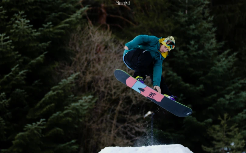 a snowboarder jumping in the air on their board