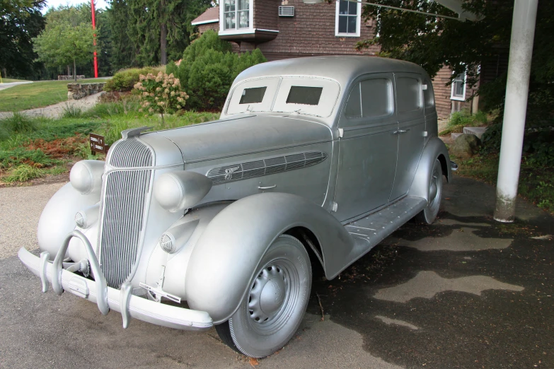 a classic car is parked on the side of the road