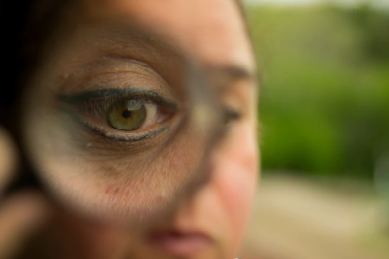 woman with a pair of eye contactive glasses and a white phone