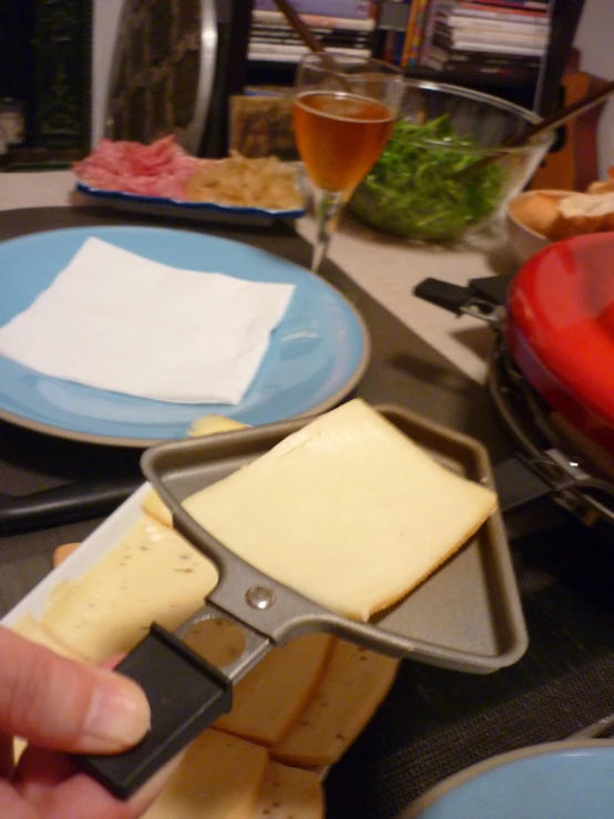 a pizza cutter  a cheese slice on a pizza