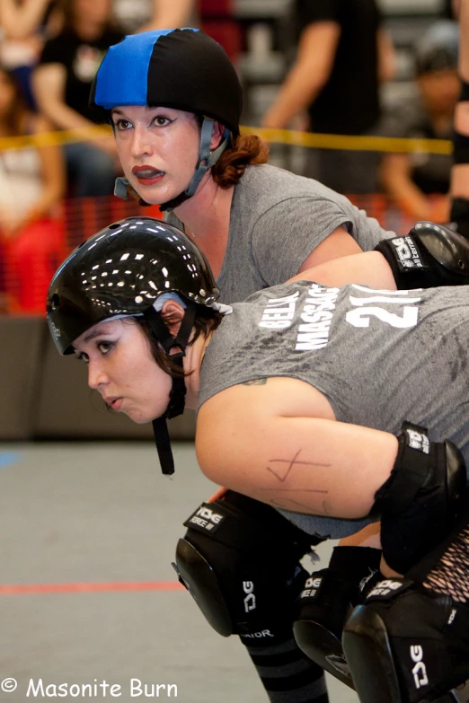 two women in roller skate gear standing next to each other