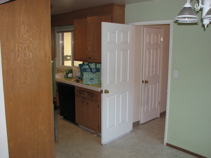 a kitchen with cabinets, refrigerator and other items