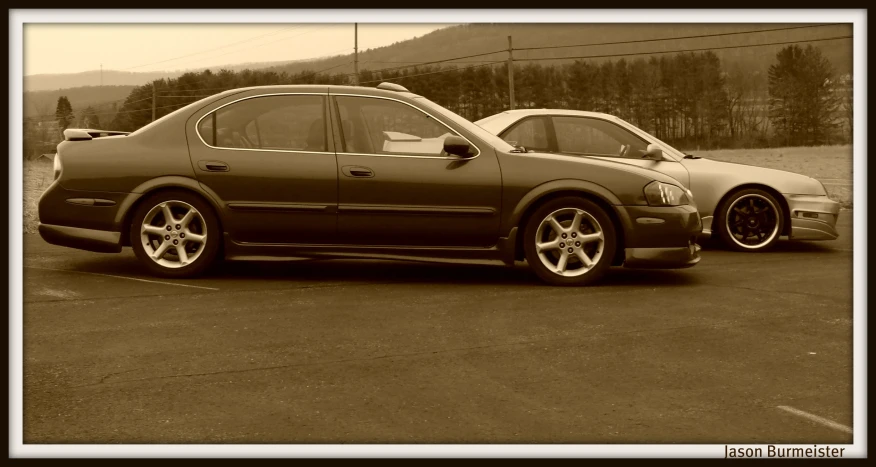 this is a sepia po of two cars parked in a parking lot