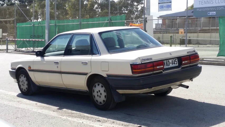 an old car is parked on the side of the road