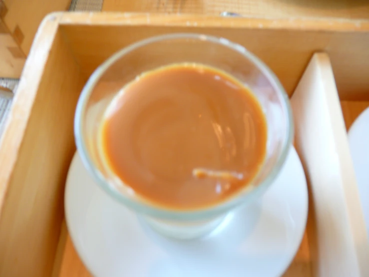 a cup of coffee in a wooden box