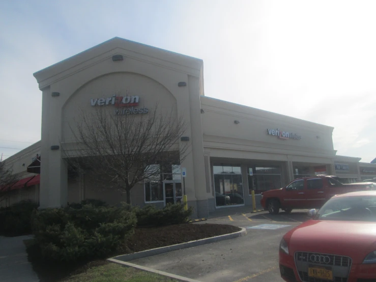 a retail building with cars in front