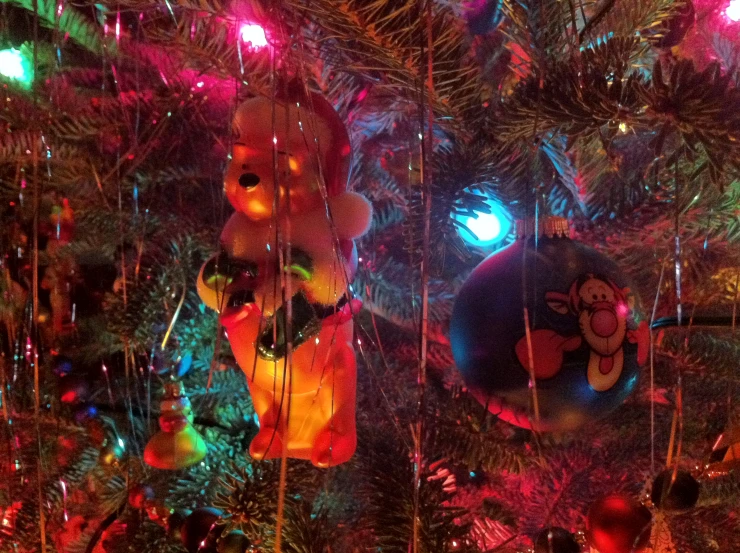 teddy bears ornaments on a christmas tree covered in lights